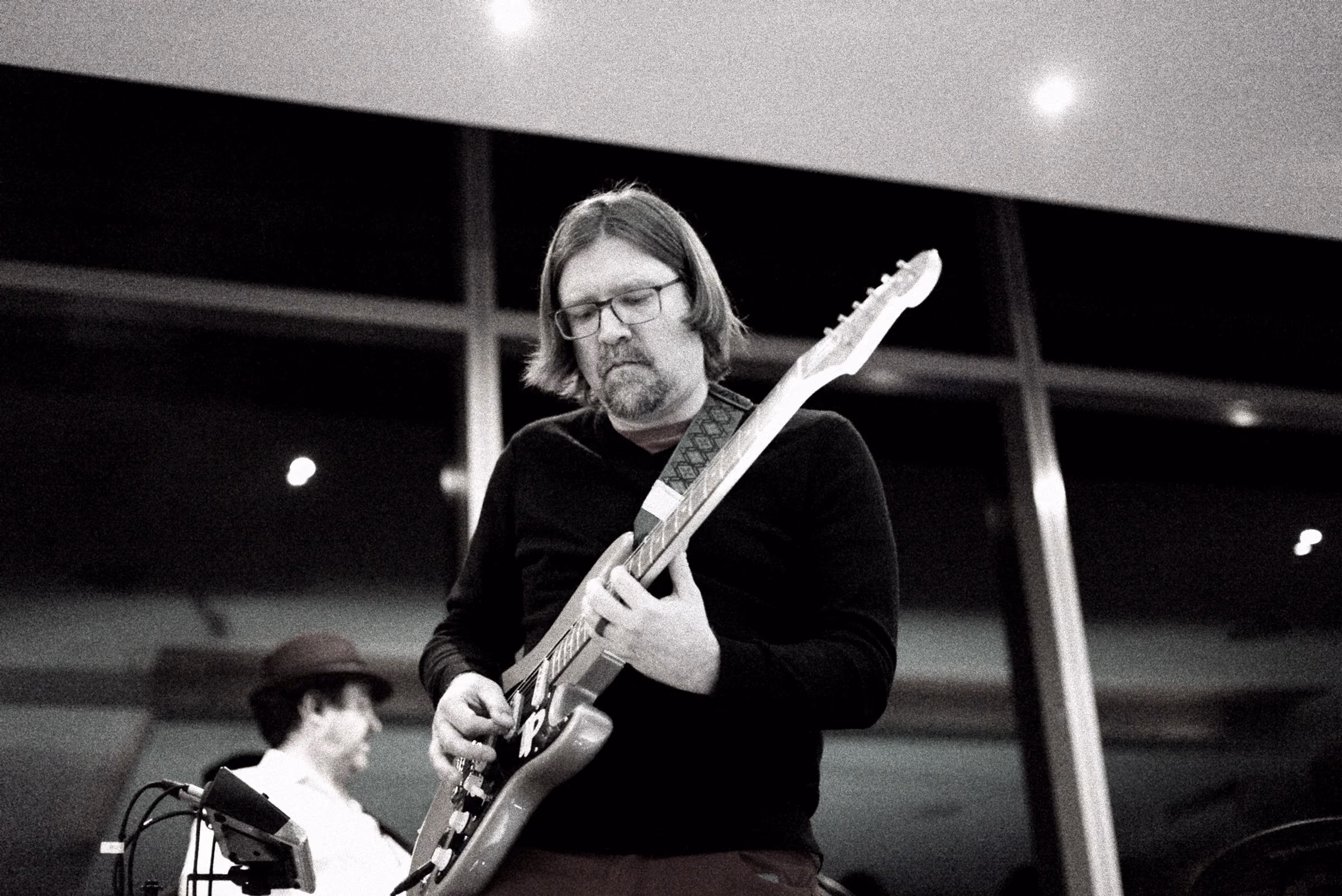 Guitarist mid-solo, in black and white